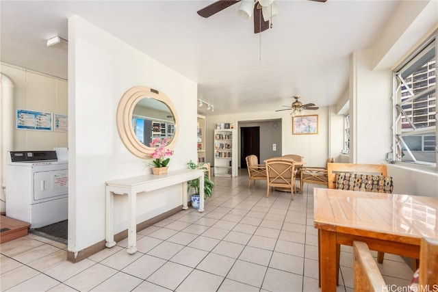 interior space with ceiling fan, light tile patterned flooring, and washer / clothes dryer