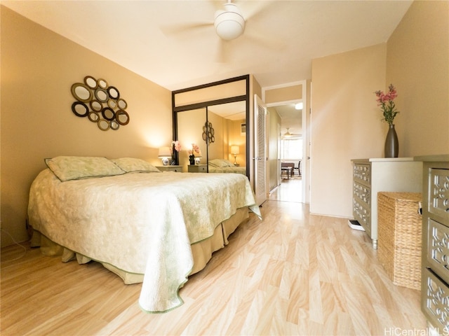 bedroom with hardwood / wood-style flooring, ceiling fan, and a closet