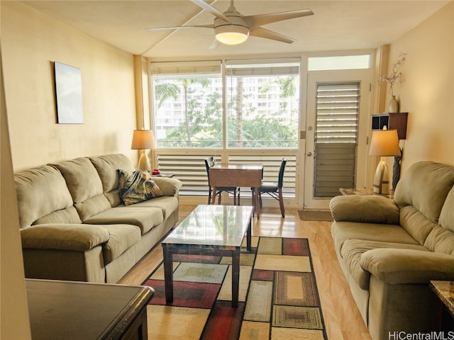 living room featuring ceiling fan and light wood-type flooring