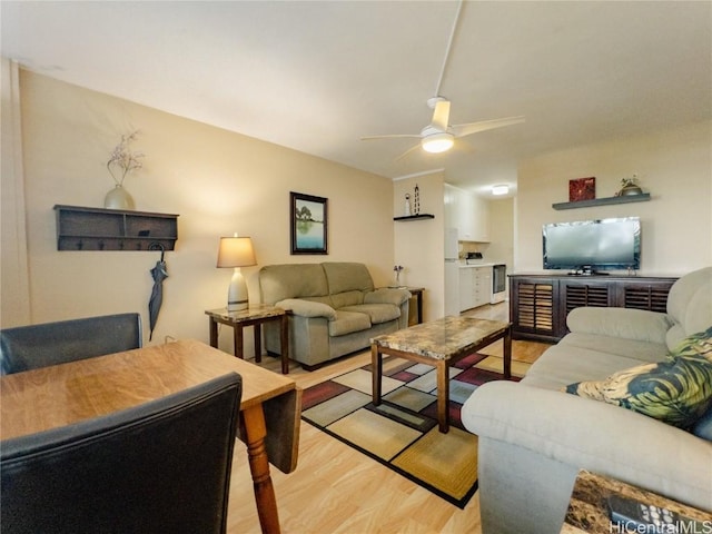 living room with ceiling fan and light hardwood / wood-style floors