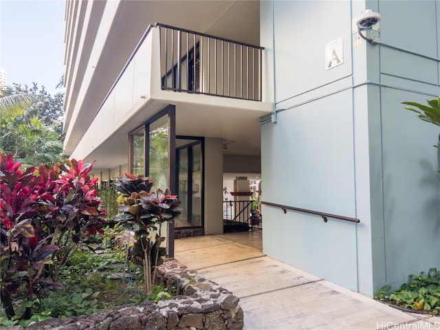 view of exterior entry with a balcony