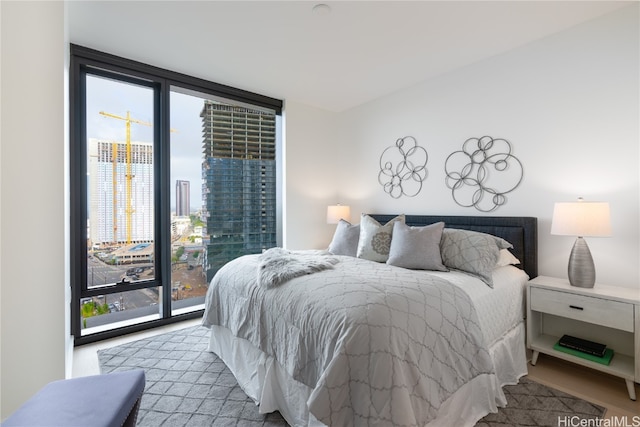 bedroom featuring access to exterior and a wall of windows