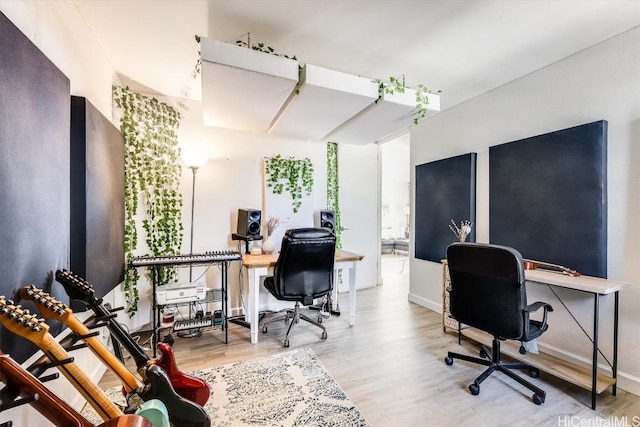 office space with baseboards and light wood finished floors