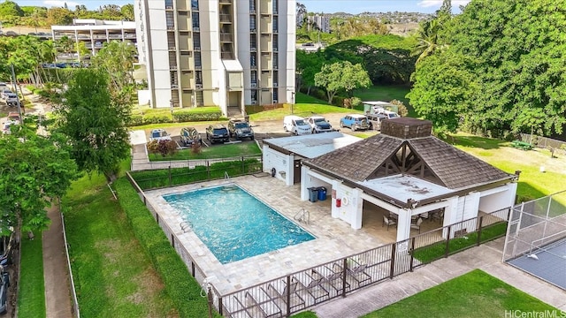 community pool featuring fence and a patio