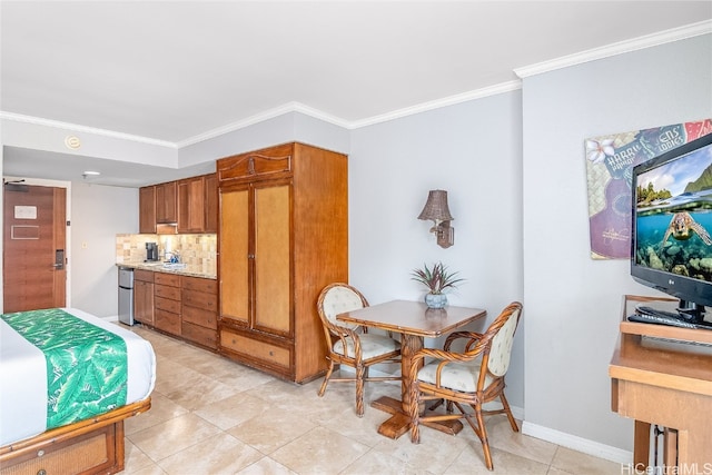 kitchen featuring decorative backsplash, light tile patterned floors, and ornamental molding