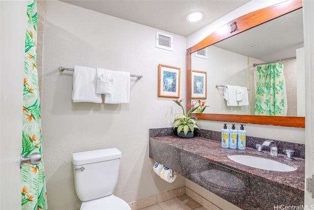 bathroom featuring a shower with curtain, sink, tile patterned flooring, and toilet