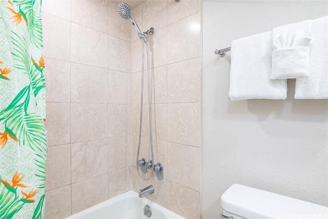 bathroom featuring toilet and shower / bathtub combination with curtain