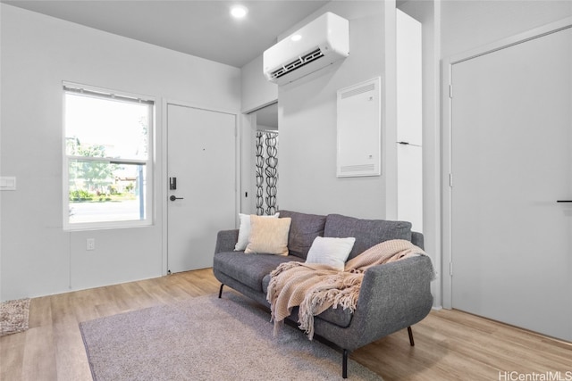 living room with light hardwood / wood-style floors and a wall mounted AC