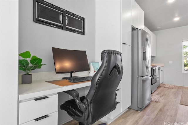 home office with light hardwood / wood-style floors