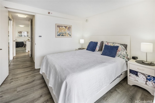 bedroom with dark hardwood / wood-style floors