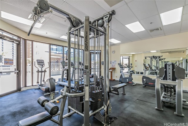 exercise room featuring a drop ceiling