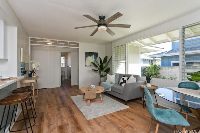 living room featuring dark hardwood / wood-style floors and ceiling fan