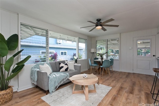 sunroom / solarium featuring ceiling fan