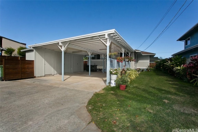 view of parking featuring a lawn and a carport