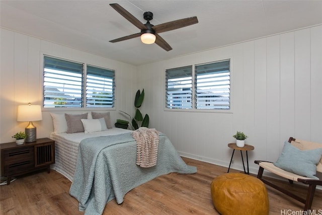 bedroom with ceiling fan and hardwood / wood-style flooring