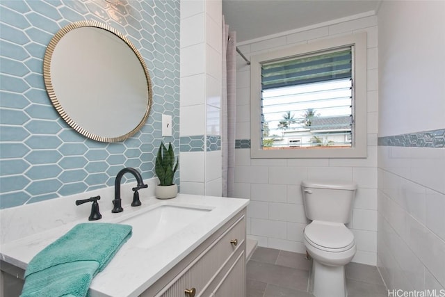 bathroom with vanity, toilet, tile walls, and curtained shower