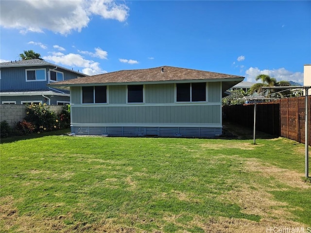 back of property featuring a lawn