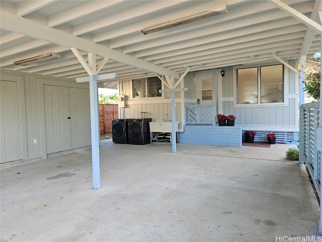 view of patio with washing machine and dryer and sink