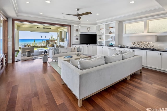 living room with dark hardwood / wood-style floors, ceiling fan, and ornamental molding