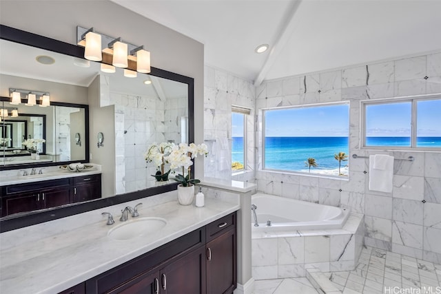 bathroom with vanity, a water view, vaulted ceiling, and independent shower and bath