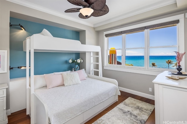 bedroom with dark hardwood / wood-style flooring, a water view, ceiling fan, and ornamental molding