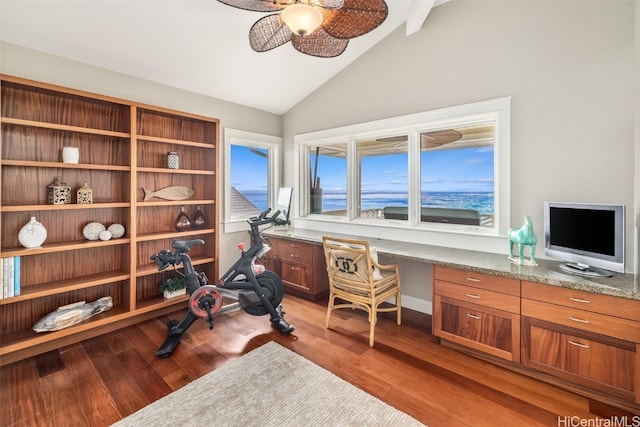 office area with hardwood / wood-style floors, built in desk, ceiling fan, and vaulted ceiling with beams