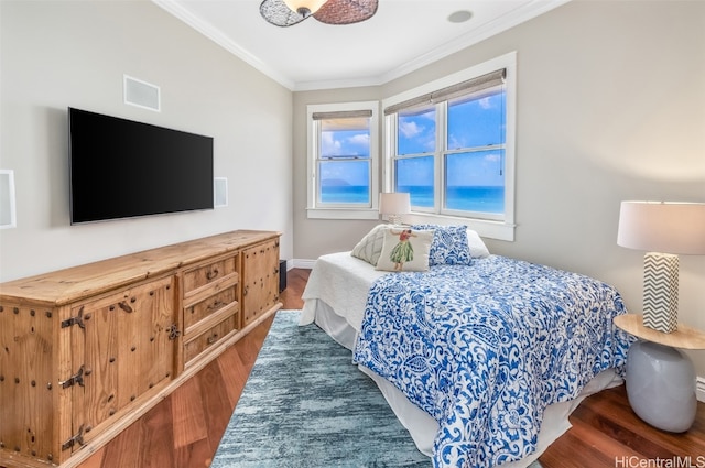 bedroom with ornamental molding and dark wood-type flooring