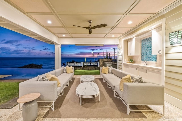 carpeted cinema with ceiling fan and sink