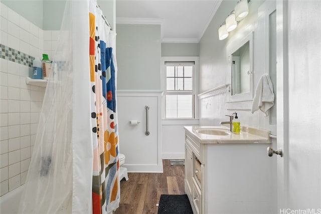 bathroom featuring vanity, hardwood / wood-style flooring, toilet, and ornamental molding