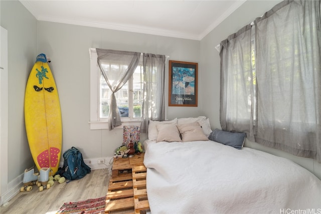 bedroom featuring wood-type flooring and ornamental molding