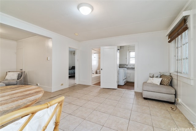 living area with ornamental molding and light tile patterned flooring