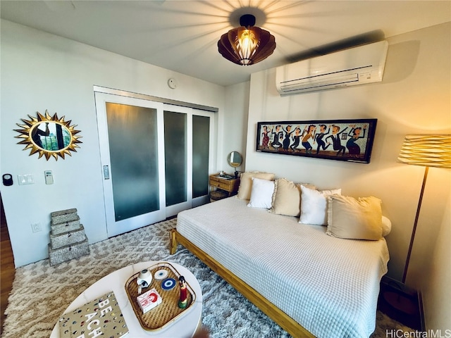 bedroom with hardwood / wood-style flooring, a wall unit AC, and a closet