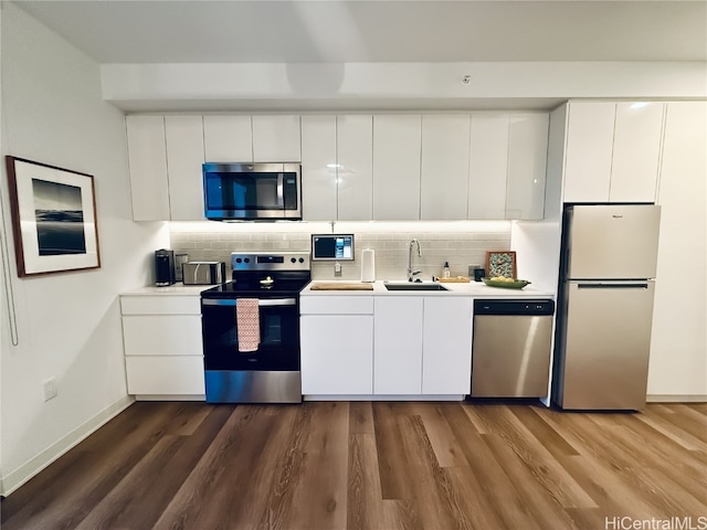 kitchen with white cabinets, wood-type flooring, sink, and appliances with stainless steel finishes