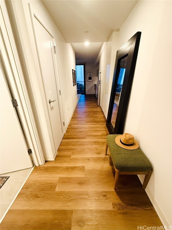 corridor with light hardwood / wood-style floors