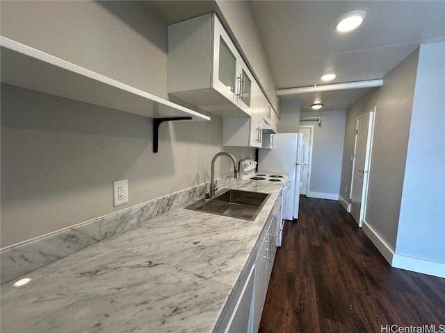 kitchen featuring light stone countertops, dark wood-type flooring, sink, white electric stove, and white cabinetry