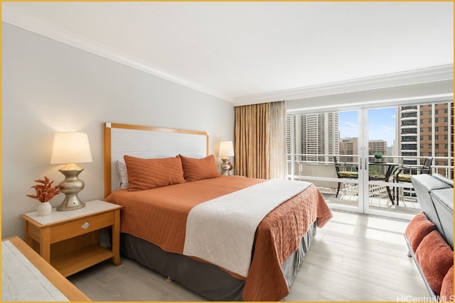 bedroom featuring wood-type flooring, crown molding, and access to outside