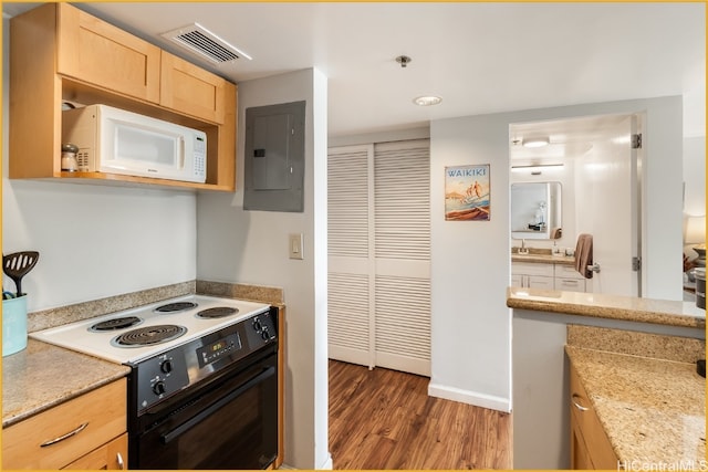 kitchen with dark hardwood / wood-style floors, white appliances, light brown cabinetry, and electric panel