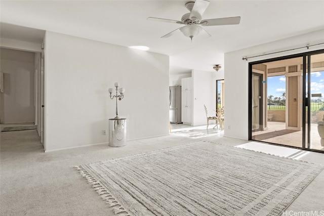 unfurnished bedroom with ceiling fan, stainless steel fridge, access to exterior, and light colored carpet