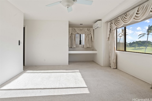 carpeted empty room with ceiling fan and a wall mounted air conditioner