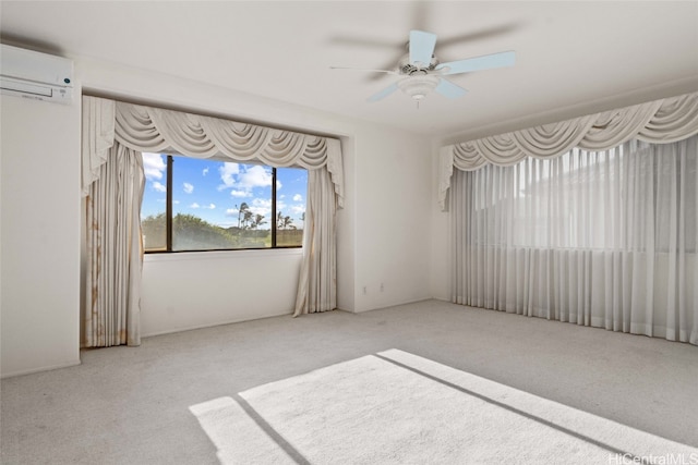 spare room with light carpet, ceiling fan, and a wall mounted air conditioner