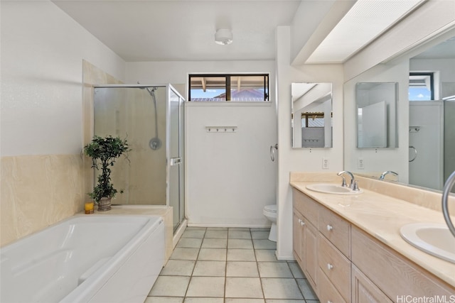 full bathroom featuring plus walk in shower, vanity, tile patterned flooring, and toilet