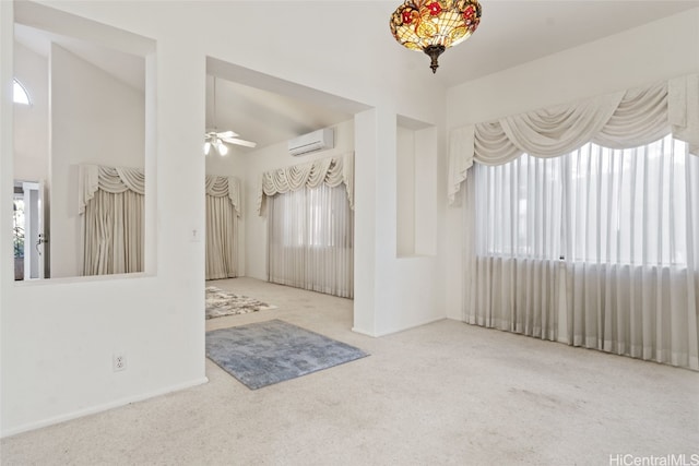 carpeted spare room featuring a wall mounted AC and ceiling fan