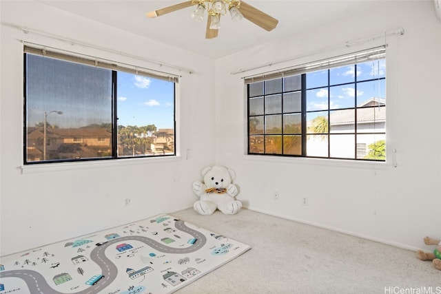 unfurnished room featuring carpet and ceiling fan