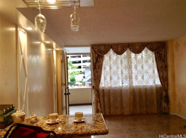 interior space with tile patterned floors and a textured ceiling