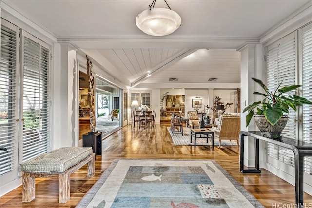 corridor featuring hardwood / wood-style flooring, vaulted ceiling with beams, wooden ceiling, and a wealth of natural light