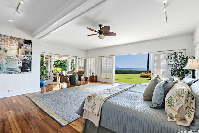 bedroom with rail lighting, ornamental molding, access to outside, ceiling fan, and wood-type flooring