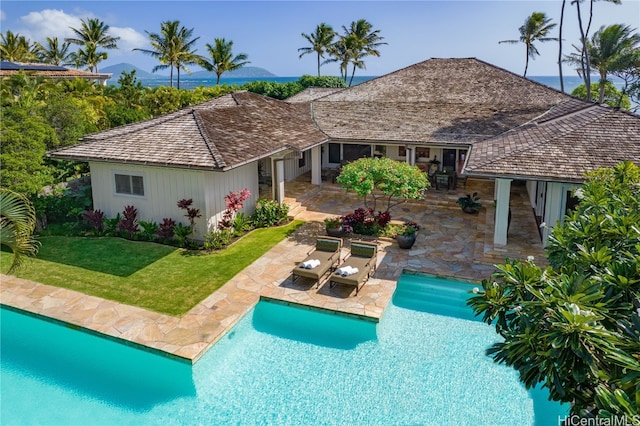 view of swimming pool featuring a yard and a patio