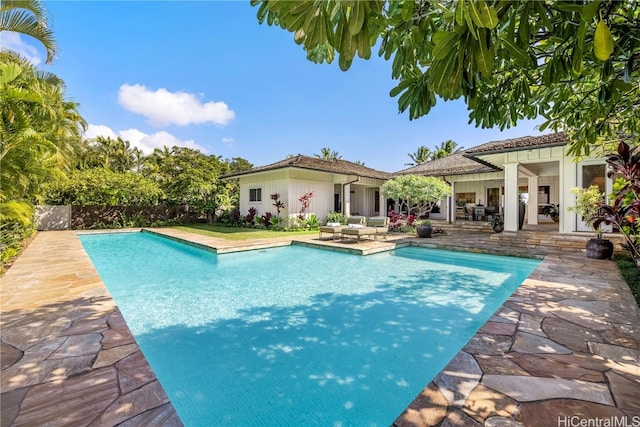 view of swimming pool with outdoor lounge area and a patio