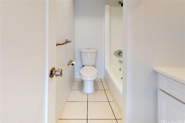 bathroom with a tub to relax in, tile patterned flooring, vanity, and toilet