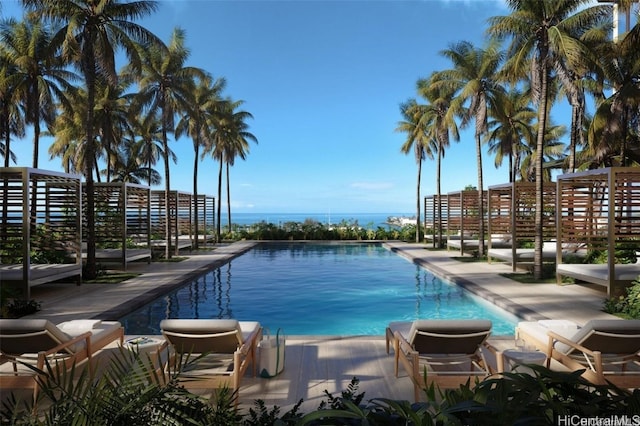 view of swimming pool featuring a patio and a water view